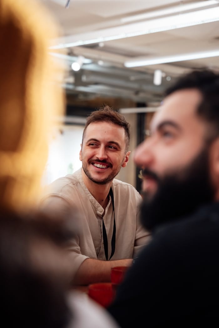 People enjoying a casual meeting in a well-lit, modern office in London, UK.