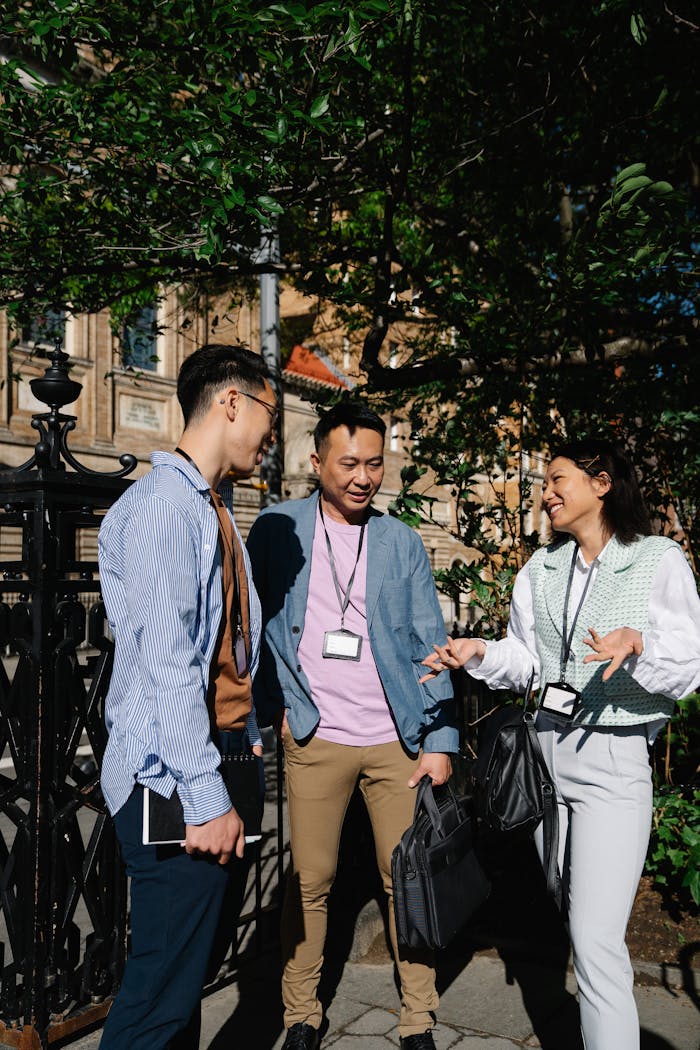 A group of colleagues engaging in a friendly conversation outdoors during a break.